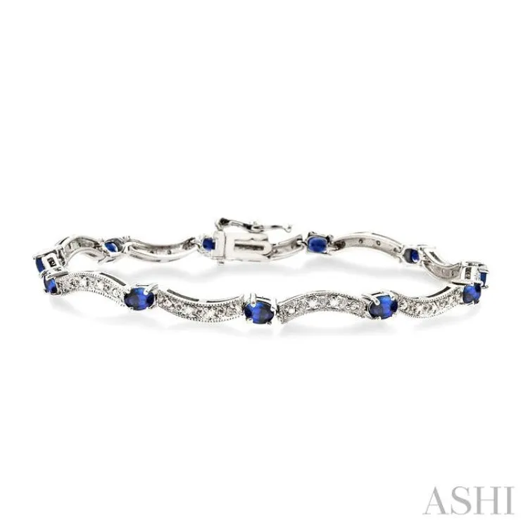 4x3mm Oval Cut Sapphire and 1/10 Ctw Single Cut Diamond Bracelet in 14K White Gold