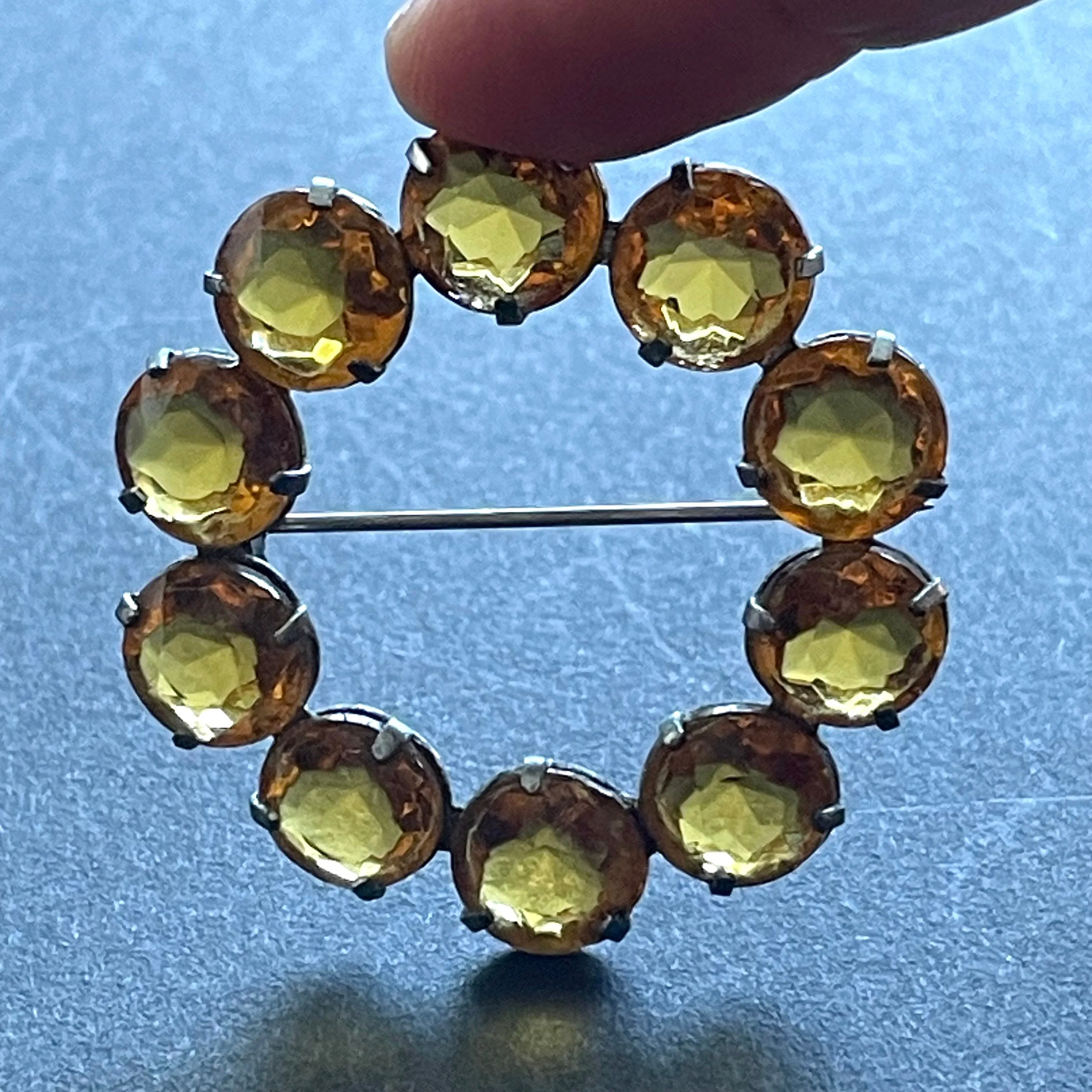 Vintage Art Deco bezel set sunshine coloured citrine yellow / orange crystal riviere circle brooch, open-backed rhinestones in silver tone